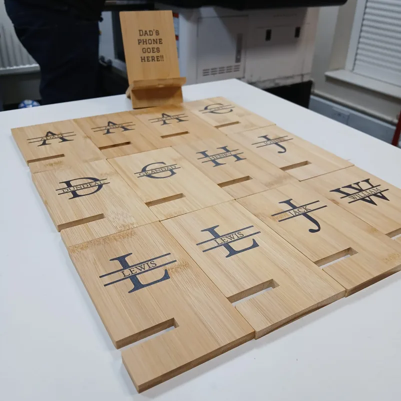 Engraved bamboo phone stands with names