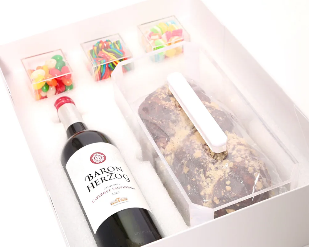 Luxury gift box with wine, brownie and sweet cubes