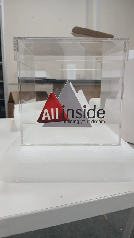 Clear acrylic display box with a printed company logo