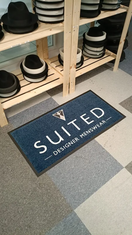 Printed logo entrance mat in a menswear shop