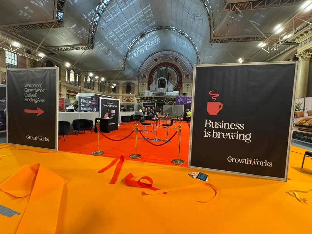 A lounge area with branded panels and a red carpet